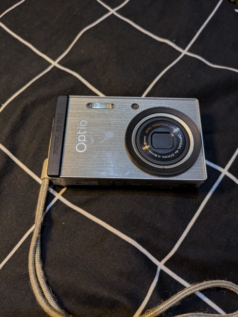 Pentax Optio RS1500 Digital Camera with Custom Skins (Category: Cameras) located in Quezon City. Submitted by stuff.decluttered (Listing ID 1448821274, Image 1). Description: 📷 [SECOND HAND] Pentax Optio RS1500 💌 Price: ₱6199 ✨ A rare customizable digicam that lets you match your camera with your outfit or aesthetic. ✨ Fully Working ✨ Buttons, zoom, and flash are functional ✨ Body Cosmetics: 10/10 ✅ 14.0 Megapixel ✅ 4x Optical Zoom ✅ Customizab