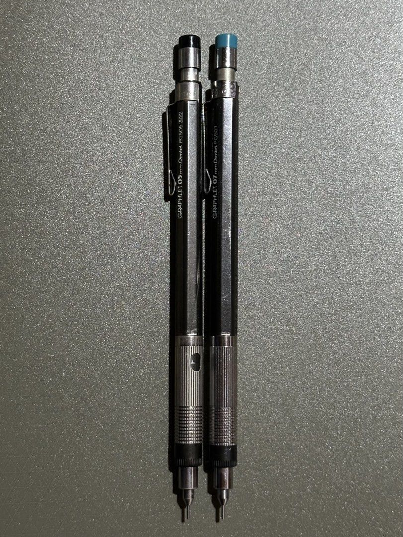Pentel Graphlet PG505 & PG507 Mechanical Pencils (Category: Stationery & School Supplies) located in Manila. Submitted by sharksfin06 (Listing ID 1448798358, Image 1). Description: 120 each Location: San Miguel, Manila MOP: Gcash MOD: J&T - Set of two Pentel Graphlet mechanical pencils - Includes 0.5mm (PG505) and 0.7mm (PG507) sizes - Sleek black body with comfortable metal grip - 0.7mm pencil features a distinct blue cap - Ideal for both writin