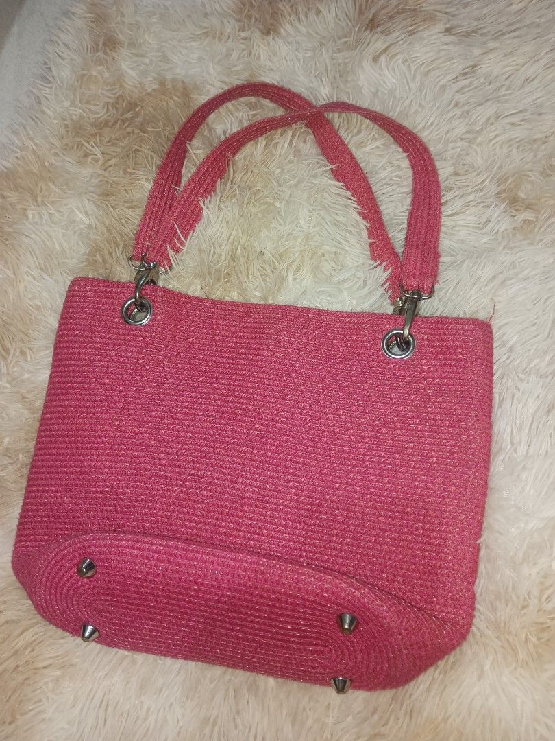 Pink Woven Tote Bag with Metal Studs (Category: Tote Bags) located in Quezon City. Submitted by cxthsells (Listing ID 1448817124, Image 1). Description: - Adorable pink woven tote bag - Features a sparkly thread woven into the material - Secure magnetic snap closure - Interior includes a zippered pocket and two slip pockets - Four metal studs on the bottom to protect the bag's base - Matching woven handles - Ideal for everyday use.