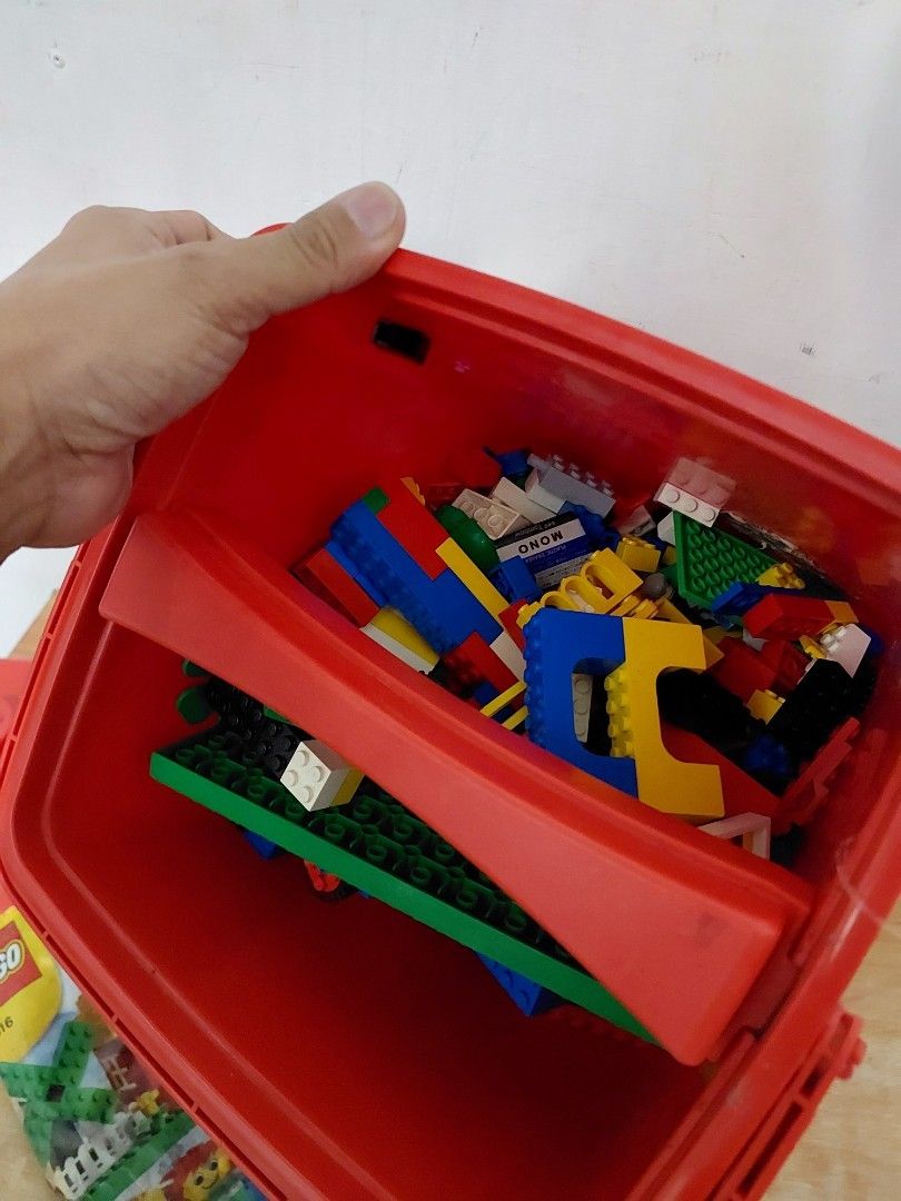 Red Lego Storage Box with Lego Bricks Inside (Category: Storage Boxes & Baskets) located in Quezon City. Submitted by jpnvintageonline (Listing ID 1448806226, Image 2). Description: - Red storage box shaped like a classic Lego brick. - Features a convenient handle for easy carrying. - Secure lid with four iconic Lego studs. - Comes pre-filled with a variety of Lego bricks (different colors and sizes). - Ideal for organizing and storing your Lego 