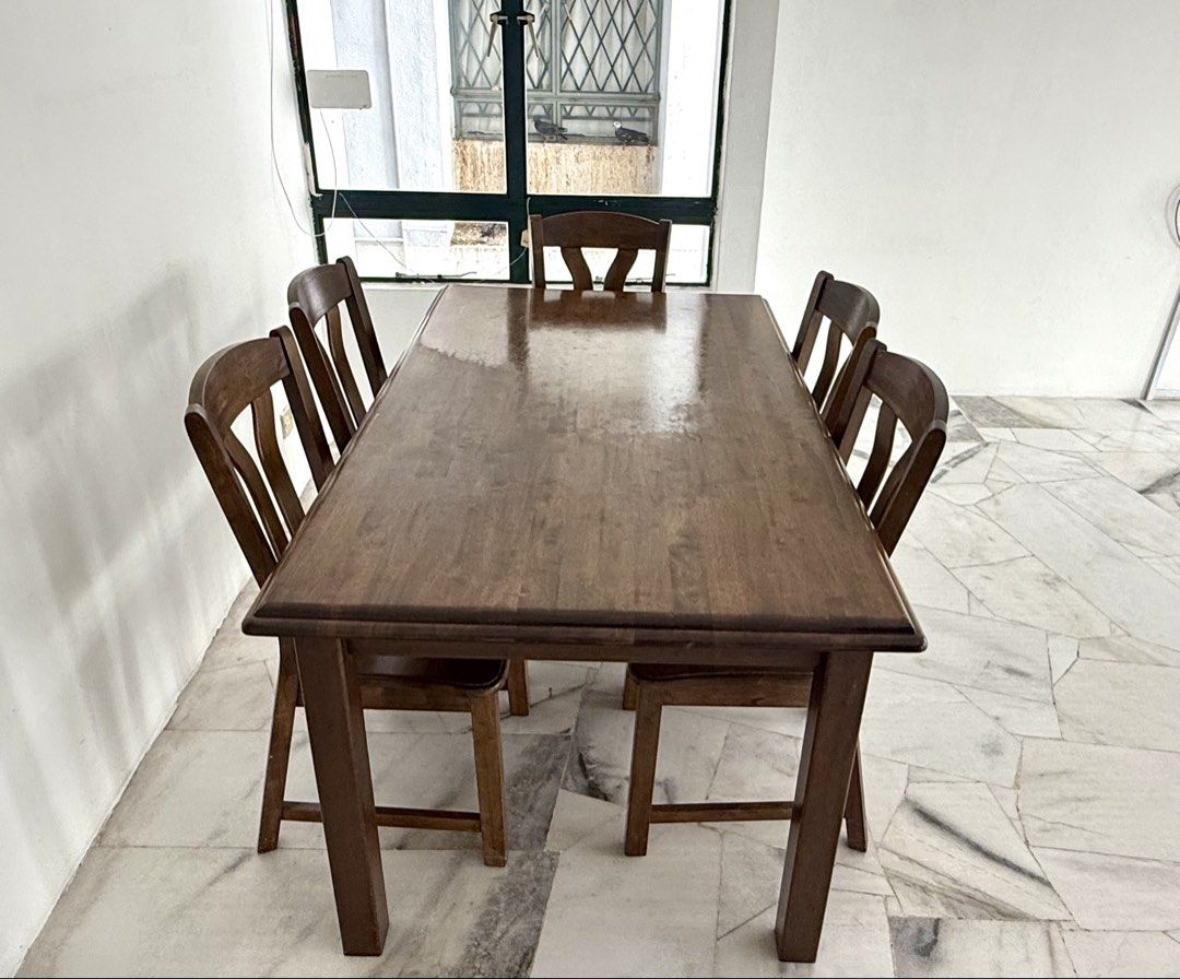 Solid Wood Dining Table Set (Category: Tables & Sets) located in Kuala Lumpur. Submitted by nurdynh12 (Listing ID 1448840374, Image 2). Description: Material: Solid Wood Seats: 5 Colour: Dark Brown - Includes 1 dining table and 5 matching chairs. - Strong and sturdy construction - Suitable for dining room, apartment, or home use - Normal signs of use but overall well maintained. - Selling as a complete set. - Self-pickup preferred. Feel free to m