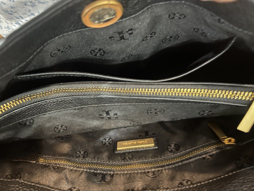 Tory Burch Black Leather Chain Shoulder Tote Bag (Category: Luxury Bags & Wallets) located in Santa Rosa. Submitted by kjcysystem (Listing ID 1448862328, Image 2). Description: - Genuine black leather Tory Burch tote bag - Elegant gold chain straps - Spacious interior with multiple compartments - Interior zippered pockets for secure storage - Signature Tory Burch logo-patterned lining - Ideal everyday bag for style and practicality.