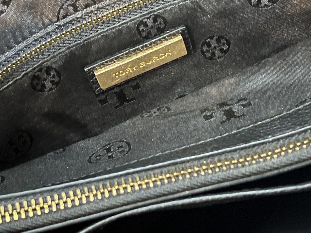 Tory Burch Black Leather Chain Shoulder Tote Bag (Category: Luxury Bags & Wallets) located in Santa Rosa. Submitted by kjcysystem (Listing ID 1448862328, Image 3). Description: - Genuine black leather Tory Burch tote bag - Elegant gold chain straps - Spacious interior with multiple compartments - Interior zippered pockets for secure storage - Signature Tory Burch logo-patterned lining - Ideal everyday bag for style and practicality.