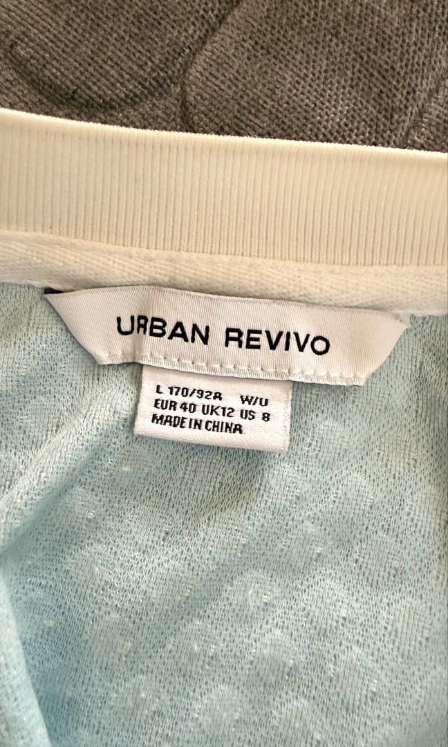 URBAN REVIVO Blue Cropped Button-Up Top (Category: Blouses) located in San Fernando. Submitted by oopssallcloset (Listing ID 1448718332, Image 2). Description: - Brand: Urban Revivo - Style: Blue cropped top - Features: Short sleeves with white trim, white buttons down the front, textured fabric - Fit: Small to Medium.