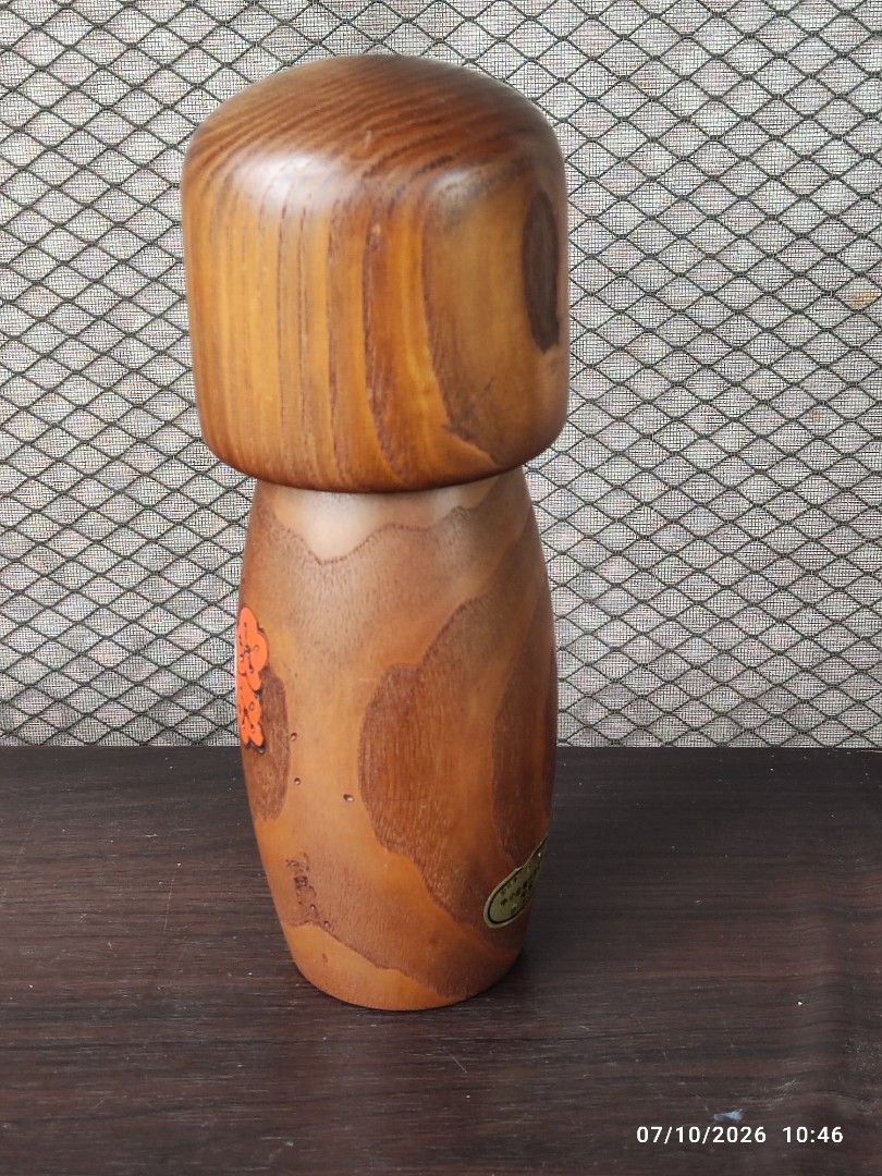 Vintage Usubaro Kokeshi Doll (Category: Vintage Collectibles) located in Tagum. Submitted by cs1907 (Listing ID 1448717198, Image 3). Description: - Authentic hand-painted Kokeshi doll from Japan. -24cm tall - Traditional design with a brown kimono featuring red and white flowers. - Classic Kokeshi style with a separate head and body. - Award-winning piece, indicated by a sticker on the bottom. - A beautiful example of Japanese folk art..