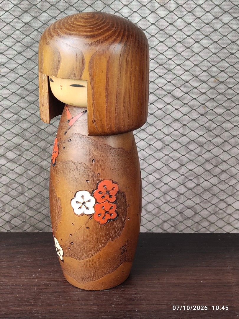 Vintage Usubaro Kokeshi Doll (Category: Vintage Collectibles) located in Tagum. Submitted by cs1907 (Listing ID 1448717198, Image 2). Description: - Authentic hand-painted Kokeshi doll from Japan. -24cm tall - Traditional design with a brown kimono featuring red and white flowers. - Classic Kokeshi style with a separate head and body. - Award-winning piece, indicated by a sticker on the bottom. - A beautiful example of Japanese folk art..