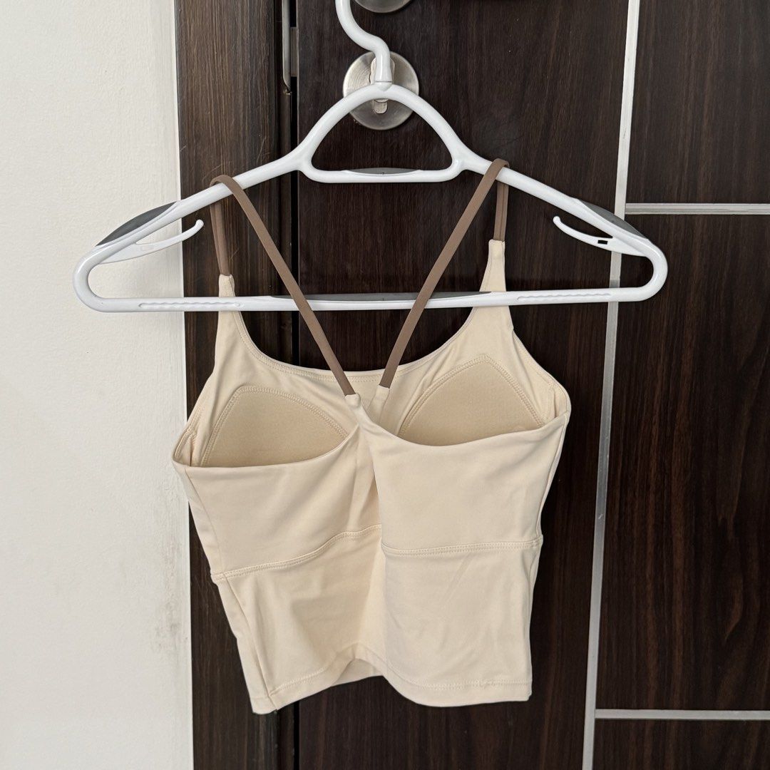 Workout Top Sports Bra (Category: Activewear) located in Manila. Submitted by declutterzoneee (Listing ID 1448742336, Image 2). Description: - Cream colored sports bra - Stylish criss-cross straps in the back - Offers comfort and support for any activity - Ideal for workouts or casual lounging - Elastic band at the bottom ensures a snug and secure fit - Versatile design pairs well with all activewear.