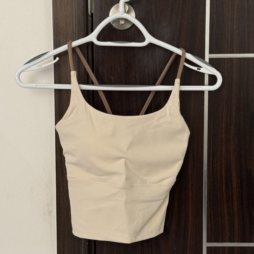 Workout Top Sports Bra (Category: Activewear) located in Manila. Submitted by declutterzoneee (Listing ID 1448742336, Image 1). Description: - Cream colored sports bra - Stylish criss-cross straps in the back - Offers comfort and support for any activity - Ideal for workouts or casual lounging - Elastic band at the bottom ensures a snug and secure fit - Versatile design pairs well with all activewear.