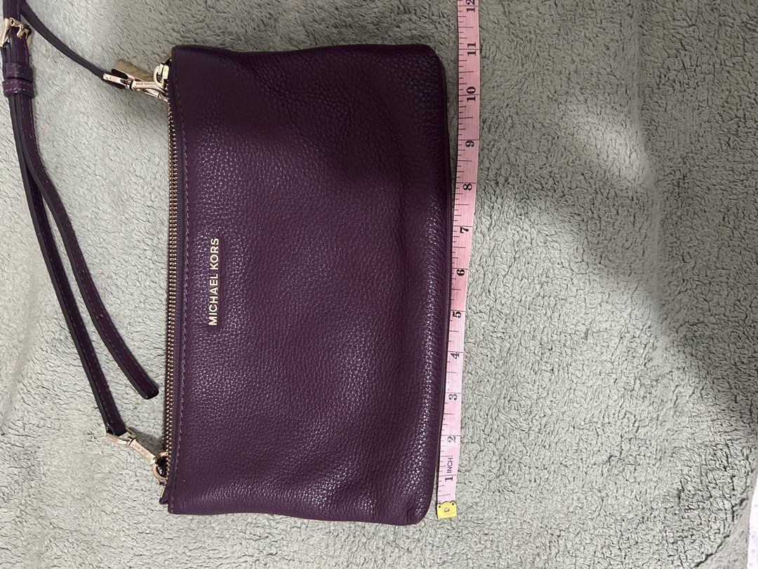 Authentic Michael Kors Purple Leather Wallet/Clutch with Strap (Category: Luxury Bags & Wallets) located in Las Pinas. Submitted by ladyattire (Listing ID 1449031132, Image 2). Description: - Authentic Michael Kors wallet - Color: Purple - Material: Pebbled leather - Hardware: Gold - Includes: Wrist strap and detachable crossbody strap - Interior: Multiple card slots - Comes with: Care card - Approximate Dimensions: 9 inches wide x 5 inches tall.