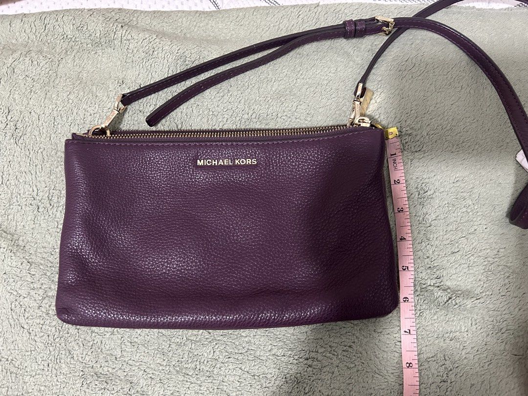 Authentic Michael Kors Purple Leather Wallet/Clutch with Strap (Category: Luxury Bags & Wallets) located in Las Pinas. Submitted by ladyattire (Listing ID 1449031132, Image 3). Description: - Authentic Michael Kors wallet - Color: Purple - Material: Pebbled leather - Hardware: Gold - Includes: Wrist strap and detachable crossbody strap - Interior: Multiple card slots - Comes with: Care card - Approximate Dimensions: 9 inches wide x 5 inches tall.