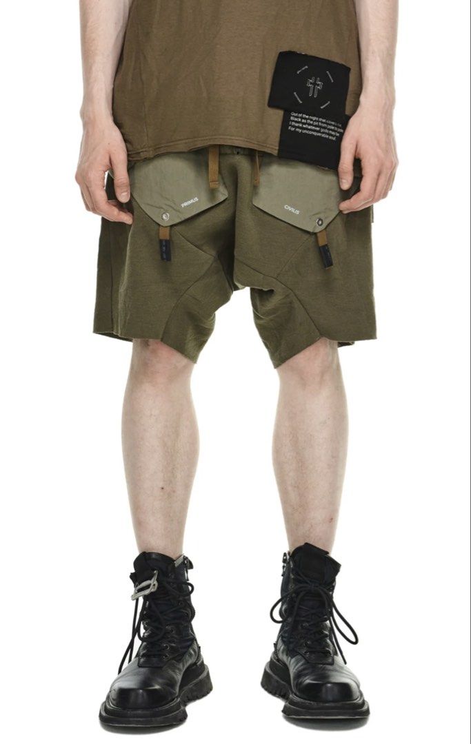 AW21 HAMCUS PRMTVSM UTILITY DROP CROTCH SHORTS (Category: Luxury Apparel) located in Balanga. Submitted by faded_garmz (Listing ID 1446213380, Image 2). Description: AW21 HAMCUS PRMTVSM UTILITY DROP CROTCH SHORTS The brand heavily integrates dystopian,, warcore aesthetics using deep garment-dyeing techniques, asymmetric cuts, and functional hardware like Fidlock buckles and modular straps HAMCUS collections are built around fictional storylines a
