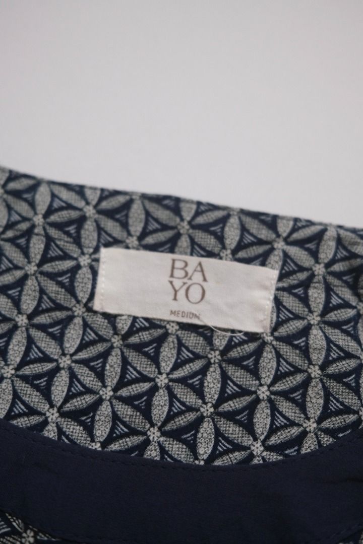 BAYO Sleeveless Top - Geometric Pattern (Category: Sleeveless) located in Naga. Submitted by billysstuff (Listing ID 1448996365, Image 2). Description: - Sleeveless top from BAYO - Features a cool geometric pattern all over - Navy blue trim around the neckline and armholes - Elasticated hem for a comfortable fit - Size: Medium - Ideal for casual everyday wear.