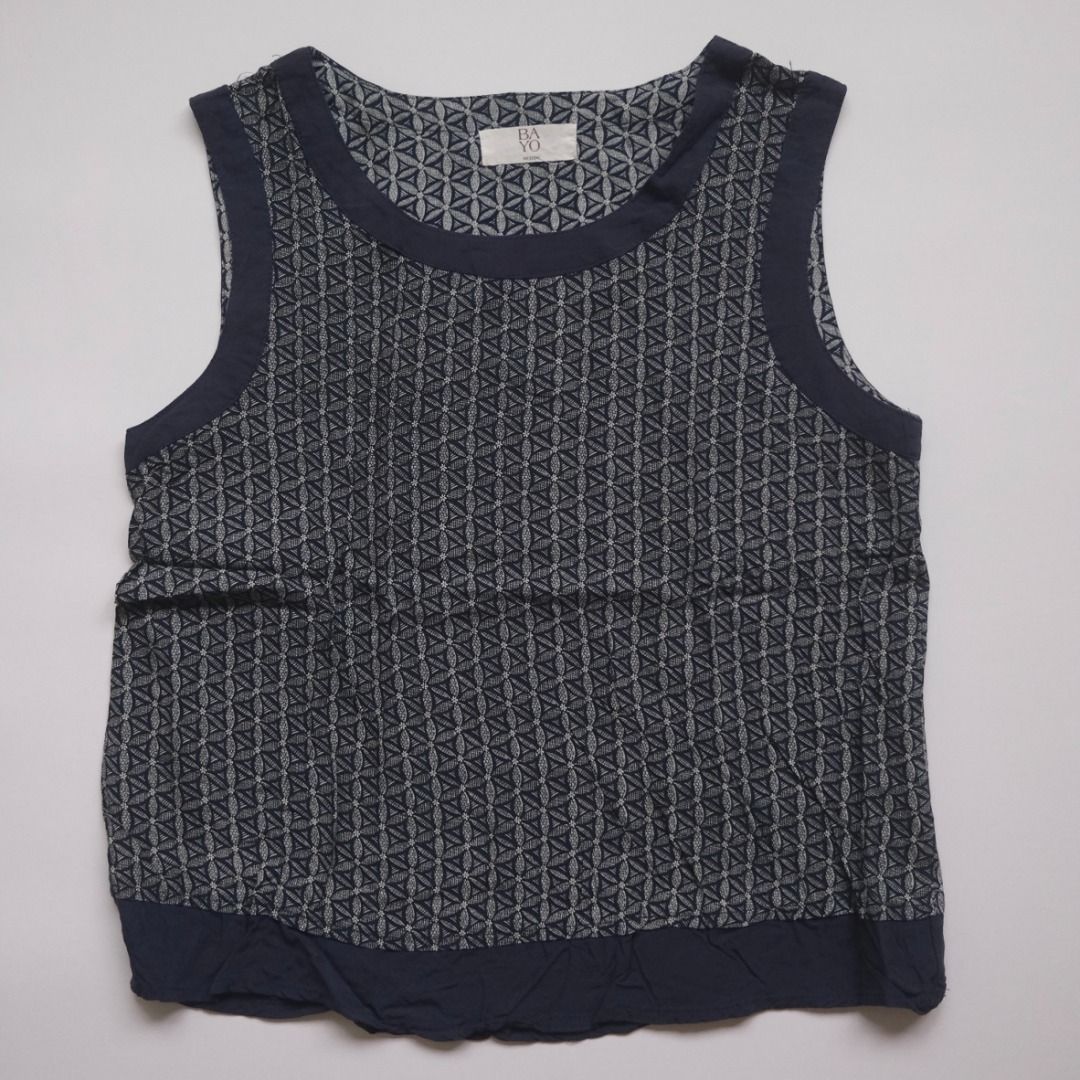 BAYO Sleeveless Top - Geometric Pattern (Category: Sleeveless) located in Naga. Submitted by billysstuff (Listing ID 1448996365, Image 1). Description: - Sleeveless top from BAYO - Features a cool geometric pattern all over - Navy blue trim around the neckline and armholes - Elasticated hem for a comfortable fit - Size: Medium - Ideal for casual everyday wear.
