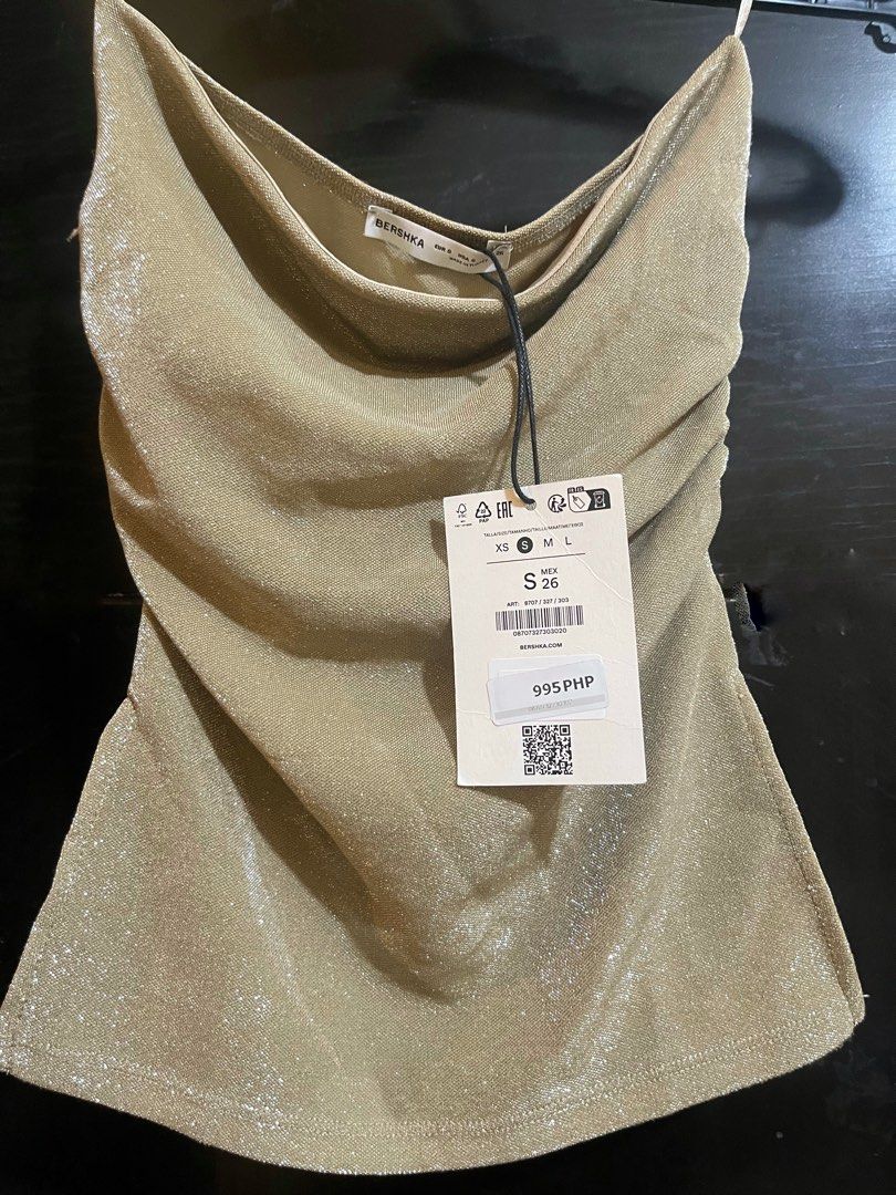 Bershka shimmery gold top (Category: Others Tops) located in Taguig. Submitted by cheks07 (Listing ID 1448995556, Image 1). Description: Bershka shimmery gold tube top ₱995 original price Stretchy.