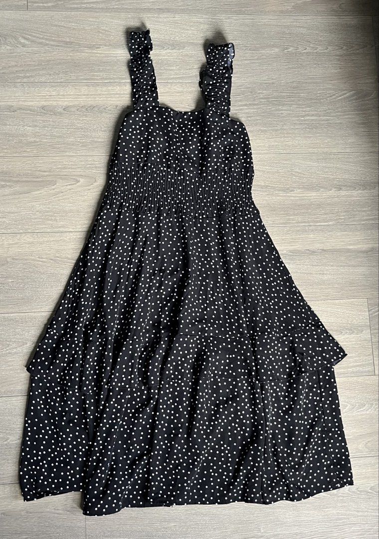 Black Polka Dot Tiered Ruffle Strap Maxi Dress (Category: Dresses) located in Mandaluyong City. Submitted by namislounge (Listing ID 1448969576, Image 1). Description: Can fit from 28-36 waist/bust | ~ 43 inches length - Cute black dress with white polka dots - Adorable ruffle straps - Flowy tiered hemline - Versatile for casual outings - Easy to style with sandals or sneakers Issue: Loose ruffled strap (can be cut or made into an off-shoulder de