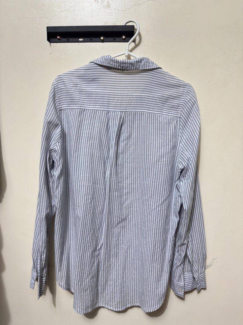 Blue and White Striped Button-Up Shirt (Category: Shirts) located in Quezon City. Submitted by weeklydeclutter (Listing ID 1448979146, Image 2). Description: - Classic blue and white striped pattern - Long sleeves with button cuffs - Button front closure - Comfortable and casual design - Ideal for everyday wear or layering l-25.5 w- 22.5.