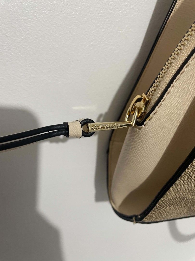 Calvin Klein Monogram Chain Shoulder Bag (Category: Luxury Bags & Wallets) located in Manila. Submitted by mikeee03 (Listing ID 1449005851, Image 3). Description: - Authentic Calvin Klein shoulder bag - Signature monogram print in beige and brown - Elegant gold chain detailing - Premium leather accents - Secure zipper closure - Includes a detachable shoulder strap for versatile styling - Spacious interior for all your essentials - Ideal for every