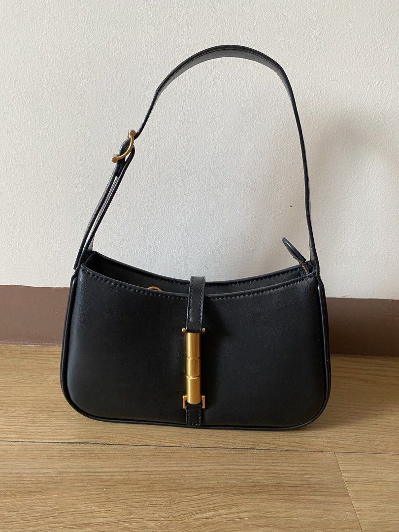 Charles & Keith Black Shoulder Bag with Gold Hardware (Category: Shoulder Bags) located in Mandaluyong City. Submitted by mac189 (Listing ID 1448968888, Image 1). Description: - Brand: Charles & Keith - Color: Black - Feature: Chic gold buckle detail on the front - Strap: Adjustable with buckle - Interior: Clean - Versatile: Great for everyday use or nights out, matches most outfits.