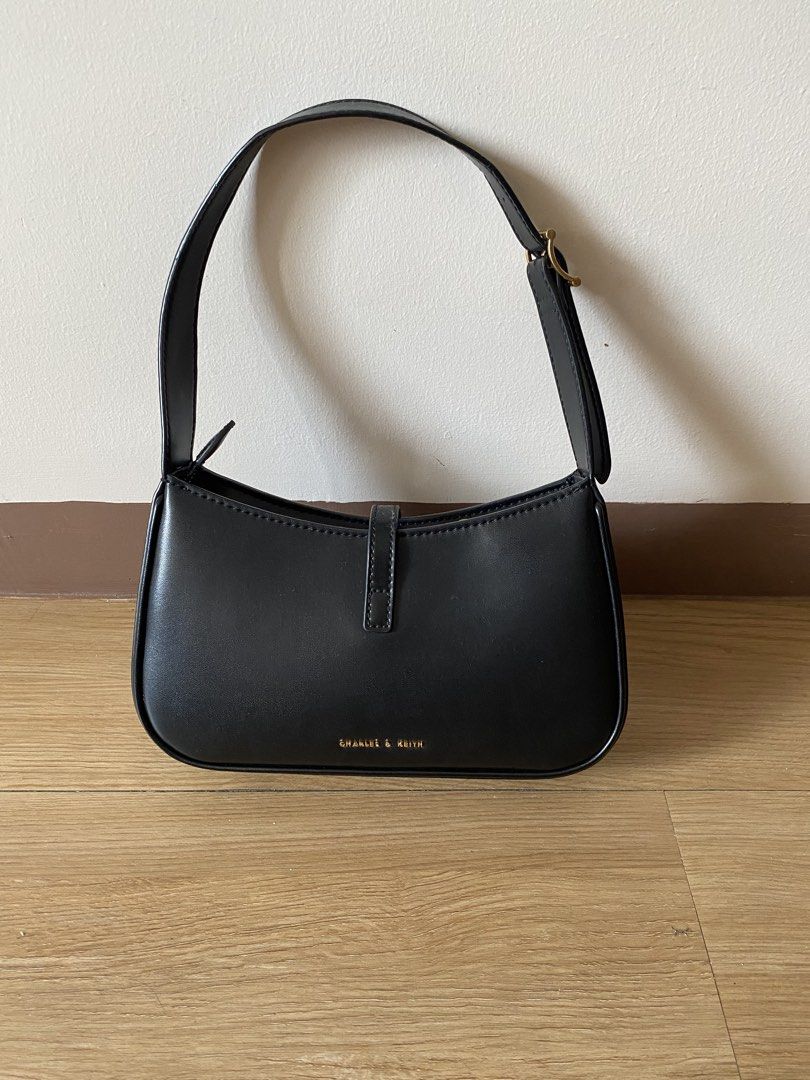 Charles & Keith Black Shoulder Bag with Gold Hardware (Category: Shoulder Bags) located in Mandaluyong City. Submitted by mac189 (Listing ID 1448968888, Image 3). Description: - Brand: Charles & Keith - Color: Black - Feature: Chic gold buckle detail on the front - Strap: Adjustable with buckle - Interior: Clean - Versatile: Great for everyday use or nights out, matches most outfits.