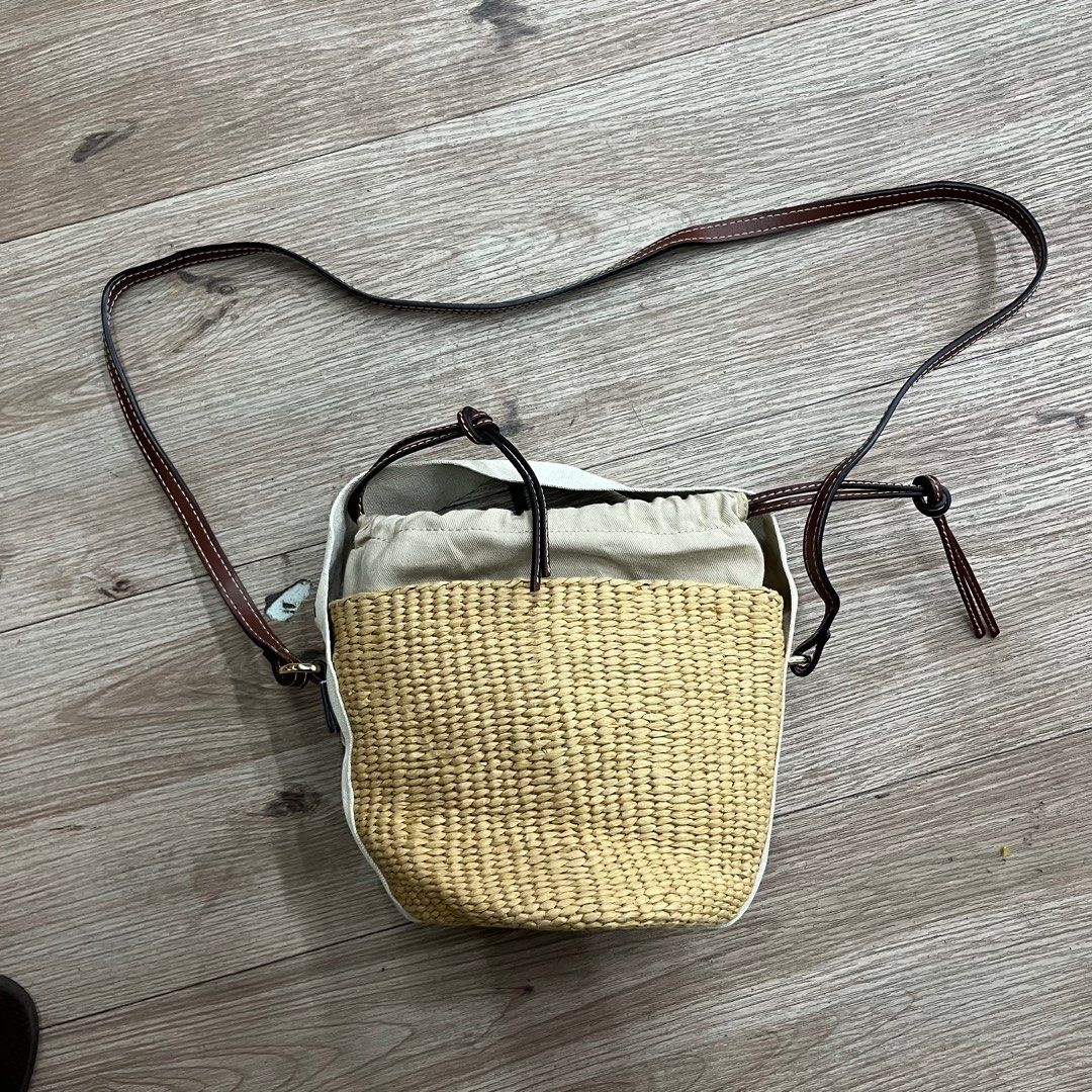 Chloe Woody Small Basket Bag (Category: Luxury Bags & Wallets) located in Iloilo. Submitted by anonymous_ph (Listing ID 1448953272, Image 2). Description: - Authentic Chloe basket bag - Iconic Woody ribbon detail - Secure drawstring closure - Perfect for summer outings - Features leather trim and strap - Approximately 7 inches tall.