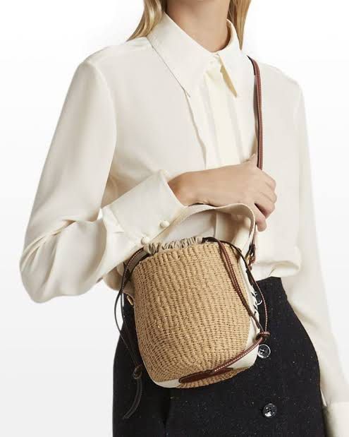 Chloe Woody Small Basket Bag (Category: Luxury Bags & Wallets) located in Iloilo. Submitted by anonymous_ph (Listing ID 1448953272, Image 1). Description: - Authentic Chloe basket bag - Iconic Woody ribbon detail - Secure drawstring closure - Perfect for summer outings - Features leather trim and strap - Approximately 7 inches tall.