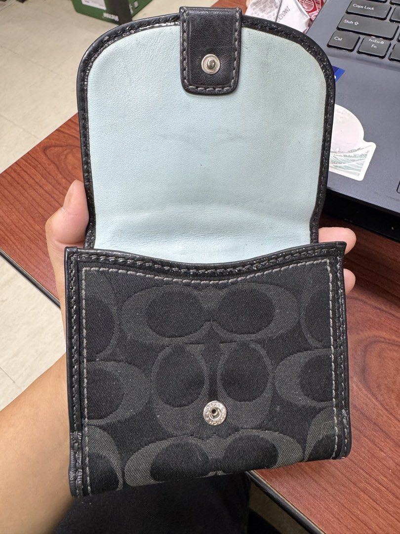 Coach Signature C Monogram Tri-Fold Wallet (Category: Luxury Bags & Wallets) located in Calamba. Submitted by gnbpreloved (Listing ID 1448924157, Image 3). Description: - Authentic Coach wallet with classic signature C monogram pattern. - Stylish black and light blue colorway. - Convenient tri-fold design with a secure buckle closure. - Interior features multiple card slots and a clear ID window. - Interior snap closure for added security. - Show