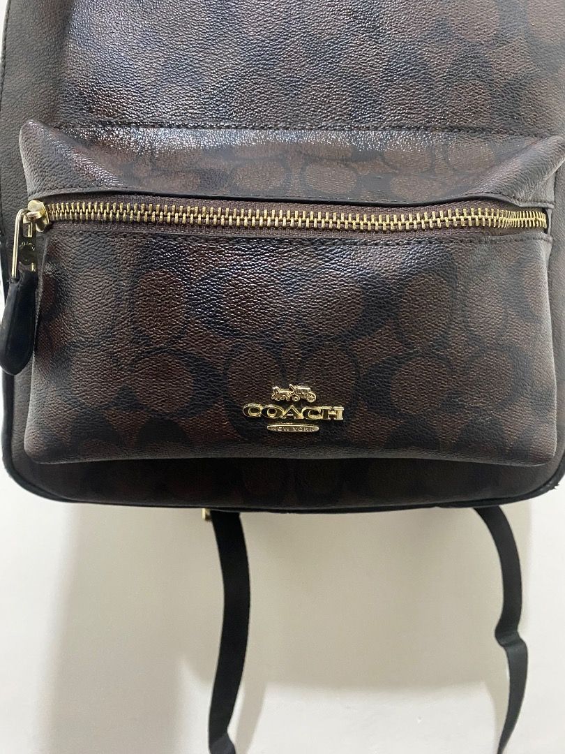 Coach Signature Monogram Backpack Brown (Category: Luxury Bags & Wallets) located in Paete. Submitted by ladder_leynn (Listing ID 1449028339, Image 2). Description: - Coach backpack - Signature monogram print in brown - Gold hardware accents - Convenient front zip pocket - Spacious interior for everyday essentials - Interior 'Made in Vietnam' tag and Coach leather patch with serial number -auth not guaranteed.