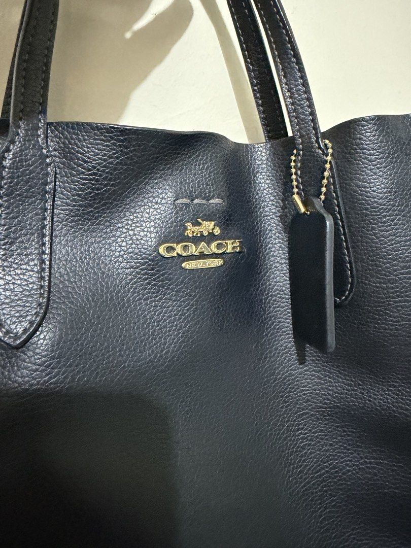 Coach Thea Bag (Category: Luxury Bags & Wallets) located in Makati City. Submitted by gkp14 (Listing ID 1449016870, Image 3). Description: - Brand: Coach - Material: Black pebbled leather - Hardware: Gold-tone - Straps: Top handles and detachable crossbody strap - Closure: Magnetic snap - Interior: Tan suede-like lining - Features: Coach authenticity tag inside - Capacity: Spacious, perfect for essentials.