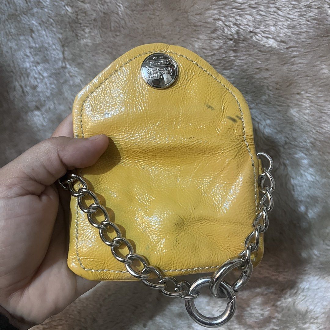 Coach Yellow Leather Coin Pouch with Chain (Category: Purses & Pouches) located in Cabadbaran. Submitted by dfgthriftology (Listing ID 1448915652, Image 3). Description: - Genuine yellow Coach coin pouch - Made of durable leather - Features a stylish silver chain - Lined with soft pink satin interior - Secure snap closure - Compact and perfect for coins or small essentials.