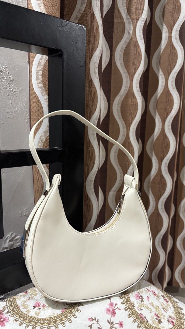 Cream Crescent Shoulder Bag (Category: Shoulder Bags) located in Laoag. Submitted by jhanelfaye (Listing ID 1449089276, Image 2). Description: - Cream colored shoulder bag - Curved crescent shape - Zipper closure along the top - Simple and chic design - Versatile for many outfits - Great for everyday use.
