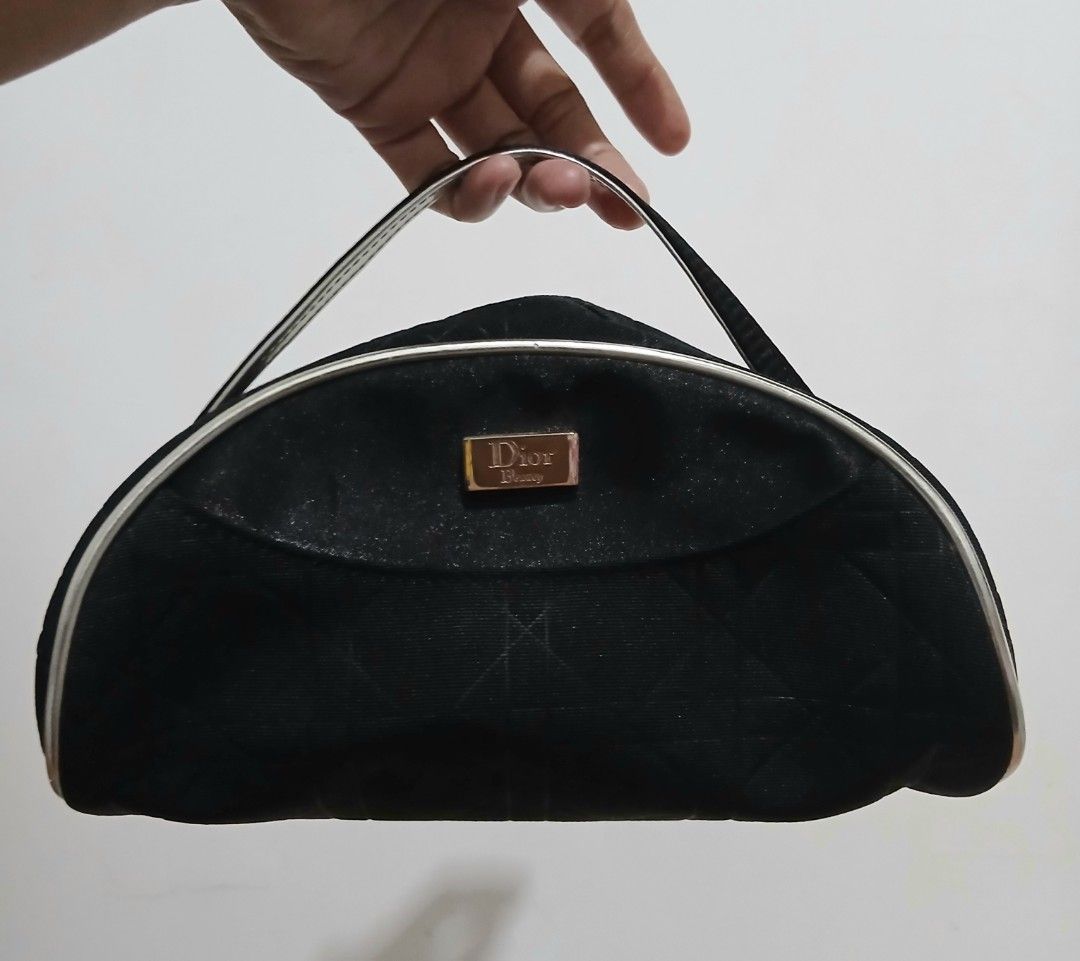 Dior Cosmetic Bag Black Monogram (Category: Luxury Bags & Wallets) located in Alaminos. Submitted by sachiKaSan (Listing ID 1448970734, Image 1). Description: - Authentic black Dior makeup bag - Features iconic Dior monogram pattern - Elegant silver trim and handle - Interior with small pockets for organization - Perfect for makeup or toiletries - Approximate dimensions: 9 inches wide x 4 inches tall.