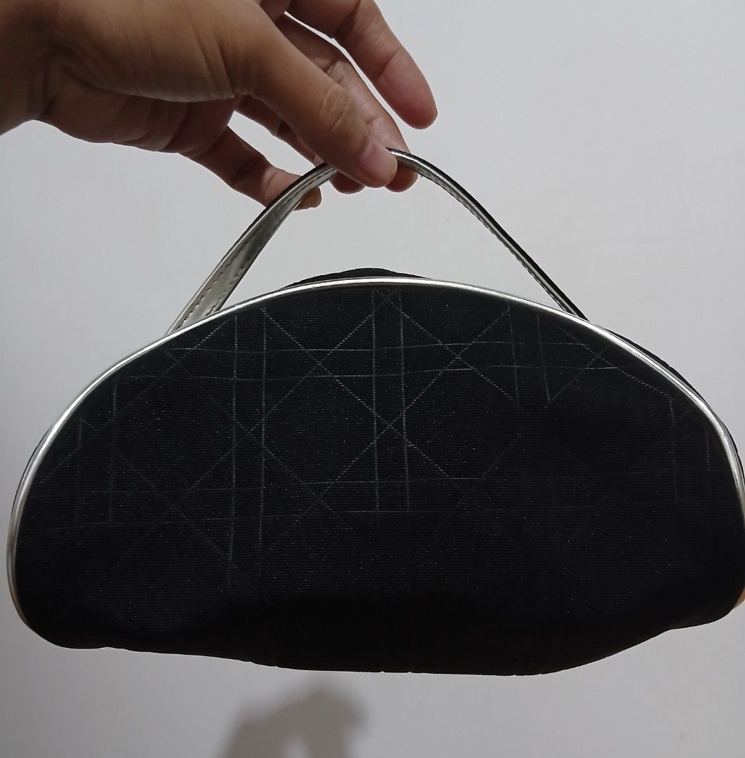 Dior Cosmetic Bag Black Monogram (Category: Luxury Bags & Wallets) located in Alaminos. Submitted by sachiKaSan (Listing ID 1448970734, Image 3). Description: - Authentic black Dior makeup bag - Features iconic Dior monogram pattern - Elegant silver trim and handle - Interior with small pockets for organization - Perfect for makeup or toiletries - Approximate dimensions: 9 inches wide x 4 inches tall.