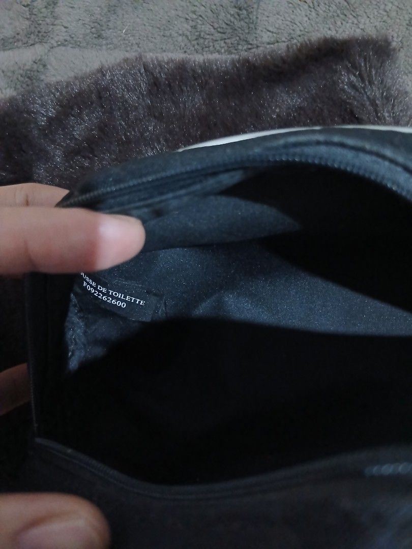 Dior Cosmetic Bag Black Monogram (Category: Luxury Bags & Wallets) located in Alaminos. Submitted by sachiKaSan (Listing ID 1448970734, Image 2). Description: - Authentic black Dior makeup bag - Features iconic Dior monogram pattern - Elegant silver trim and handle - Interior with small pockets for organization - Perfect for makeup or toiletries - Approximate dimensions: 9 inches wide x 4 inches tall.