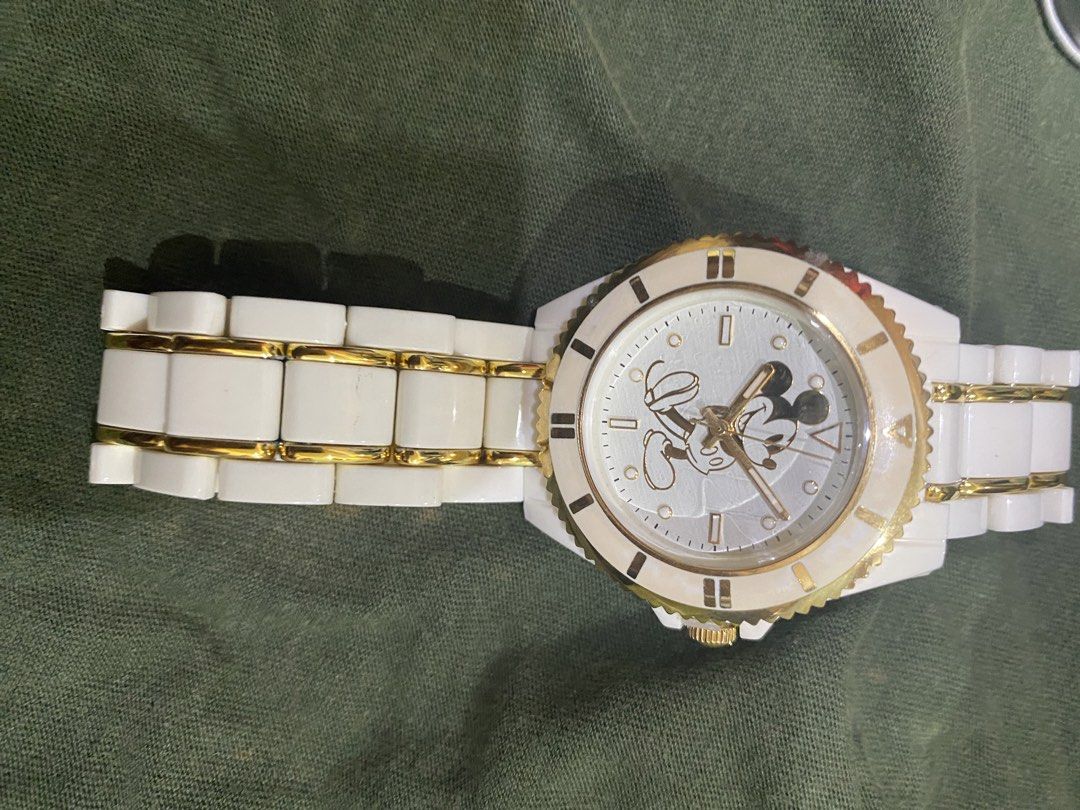 Disney Mickey Mouse White Ceramic Gold Watch (Category: Women's Watches) located in Makati City. Submitted by jdeep9 (Listing ID 1449059634, Image 2). Description: -lightweight watch. Strap is plastic material - Features a charming Mickey Mouse design on the watch face - Secure clasp closure - Comes in a collectible metal tin can - Ideal gift for any Disney fan! -never used. Natambak lang .