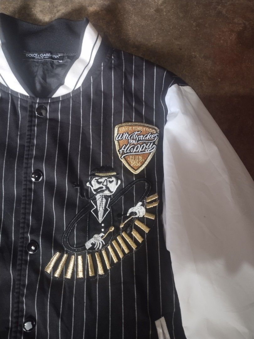 Dolce & Gabbana Striped Bomber Jacket (Category: Luxury Apparel) located in Valencia. Submitted by coolwolf_27a64f (Listing ID 1448923442, Image 3). Description: - Authentic Dolce & Gabbana Bomber Jacket - Color: Black body with white pinstripes, white sleeves - Features: Embroidered details on the front - Origin: Made in Italy - Size: 50 S- M - Condition: Great piece for your collection.