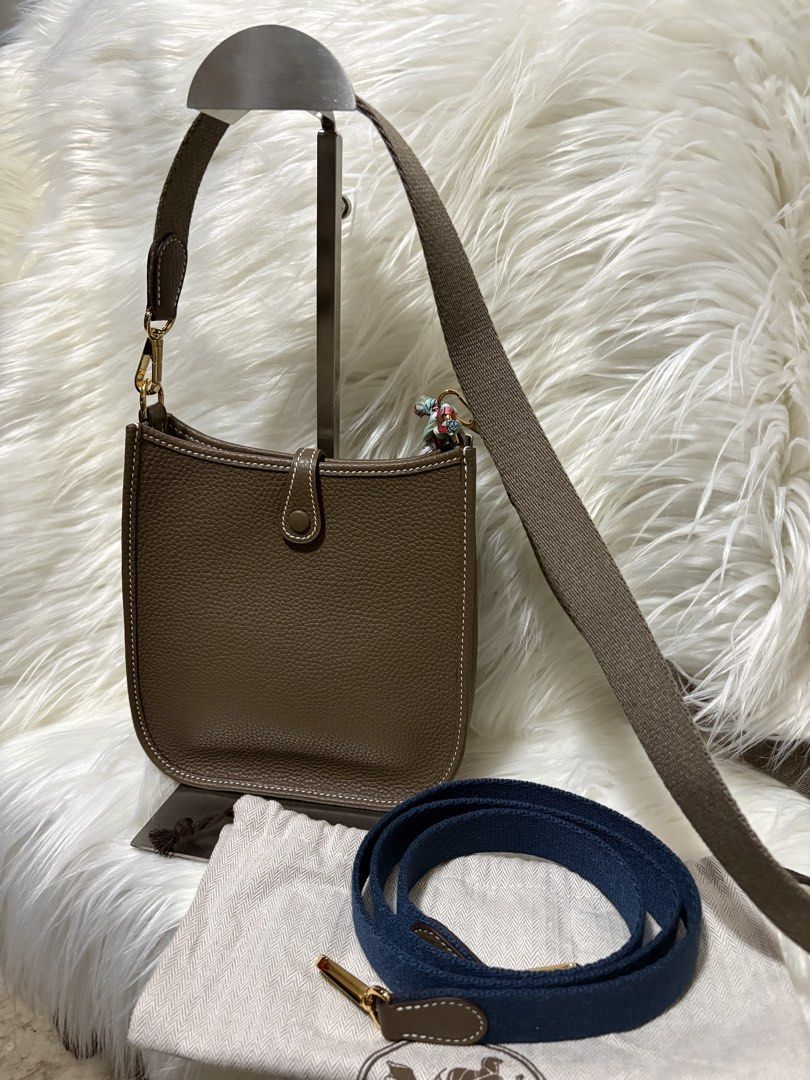 Evelyne TPM Shoulder Bag (Category: Luxury Bags & Wallets) located in Mandaue City. Submitted by zealhawk_ca52e0 (Listing ID 1448916819, Image 2). Description: - Evelyne size TPM bag - Color: Taupe - Hardware: Gold - Includes: dust bag, extra blue canvas strap, mini bag charm - Ideal for everyday use.