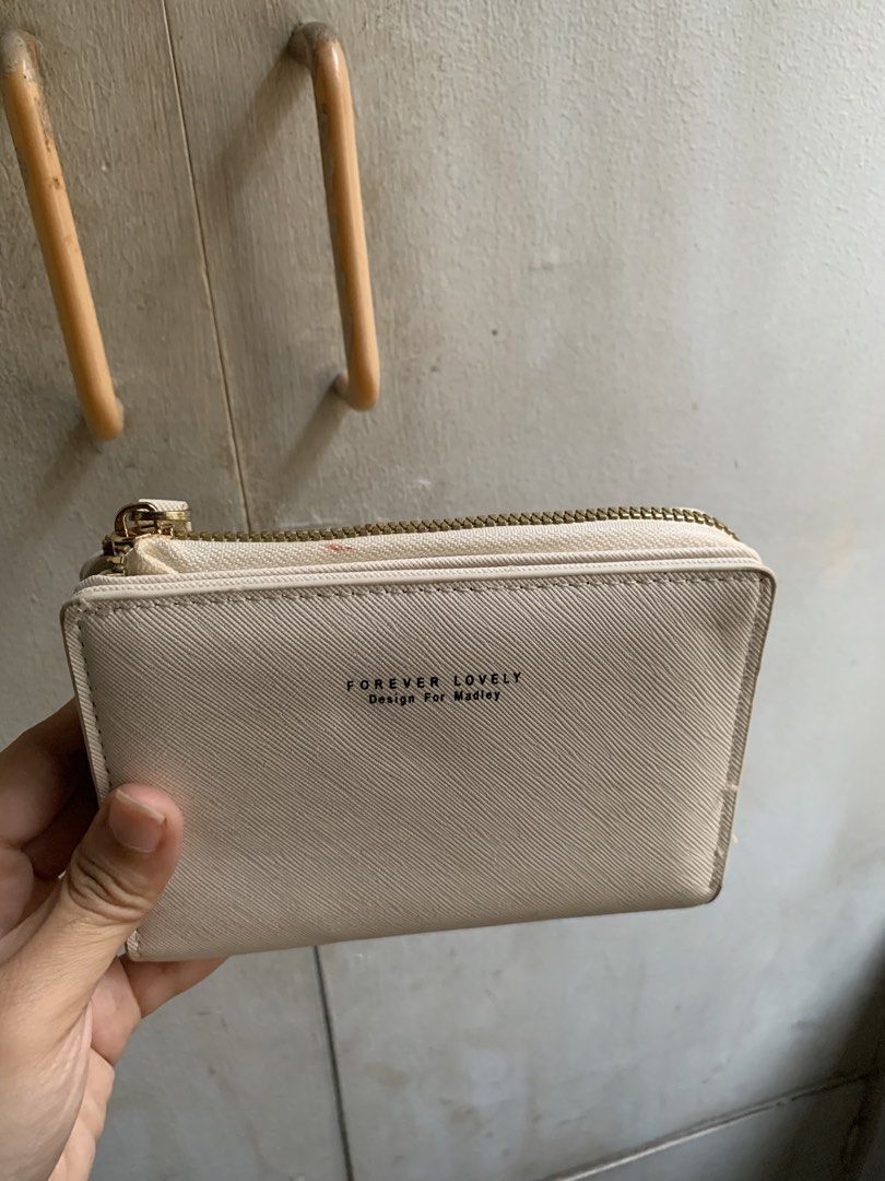 Wallet (Category: Wallets & Card holders) located in Manila. Submitted by usagichan_rabbit (Listing ID 1449105369, Image 1). Description: - Brand: Forever Lovely - Design: Madley - Color: Beige/Cream - Features: Multiple card slots, Zipper closure good condition needs cleaning.