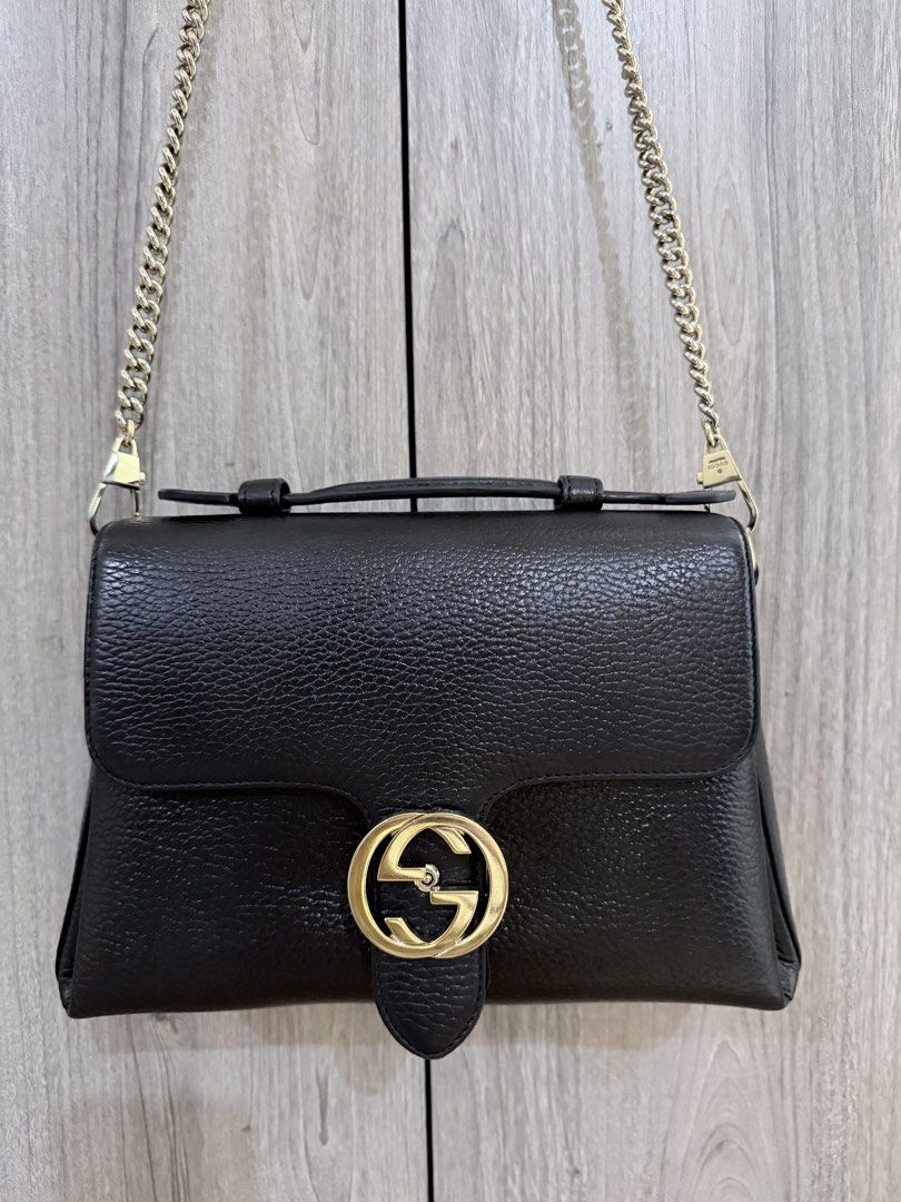 GUCCI Black Pebbled Leather Interlocking Top Handle Bag (Category: Luxury Bags & Wallets) located in Manila. Submitted by vra.luxe (Listing ID 1449023314, Image 1). Description: - Authentic black leather Gucci bag - recolored to black - Iconic gold GG logo hardware - Multiple interior compartments for organization - with chain strap - Clean interior - Ideal everyday bag - others sell this for 50k.