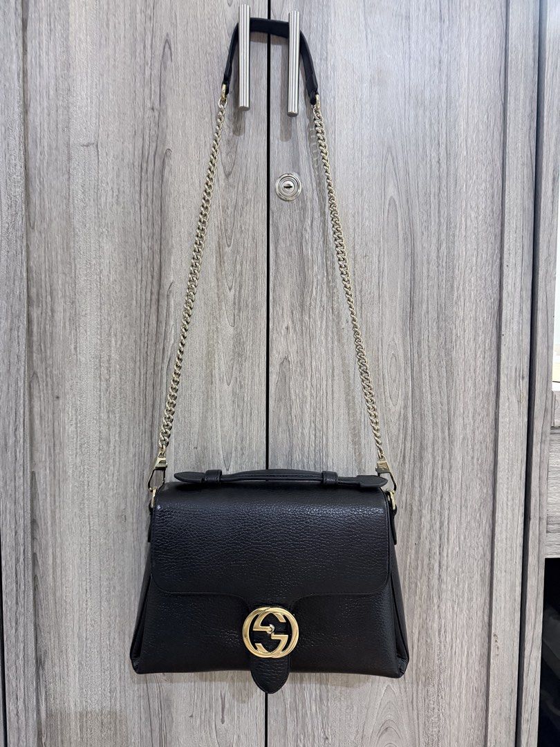 GUCCI Black Pebbled Leather Interlocking Top Handle Bag (Category: Luxury Bags & Wallets) located in Manila. Submitted by vra.luxe (Listing ID 1449023314, Image 2). Description: - Authentic black leather Gucci bag - recolored to black - Iconic gold GG logo hardware - Multiple interior compartments for organization - with chain strap - Clean interior - Ideal everyday bag - others sell this for 50k.