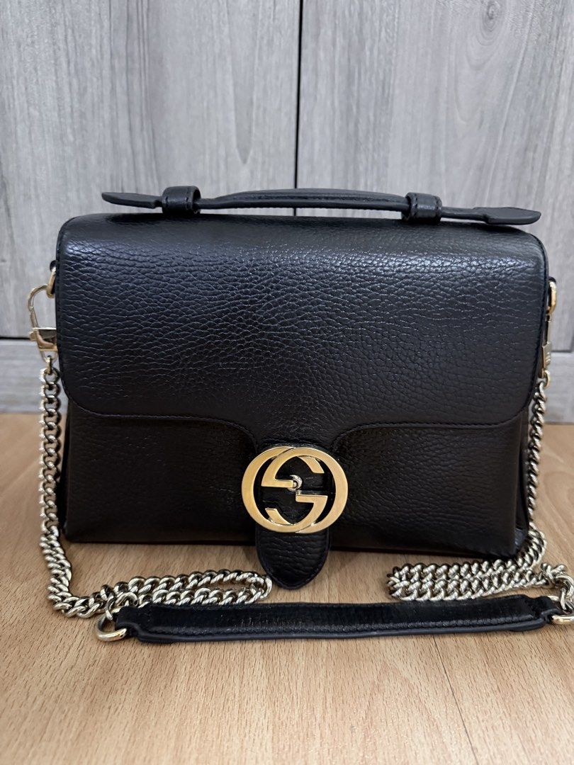 GUCCI Black Pebbled Leather Interlocking Top Handle Bag (Category: Luxury Bags & Wallets) located in Manila. Submitted by vra.luxe (Listing ID 1449023314, Image 3). Description: - Authentic black leather Gucci bag - recolored to black - Iconic gold GG logo hardware - Multiple interior compartments for organization - with chain strap - Clean interior - Ideal everyday bag - others sell this for 50k.