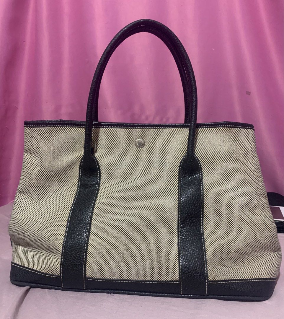 Hermes Canvas and Leather Tote Bag (Category: Luxury Bags & Wallets) located in Balagtas. Submitted by ibeautyph (Listing ID 1449098027, Image 2). Description: - Classic Hermes tote bag - Beige canvas with black leather trim and handles - Iconic Hermes snap closure - Spacious interior - Ideal for everyday use or travel - A timeless addition to your collection (not guaranteed).