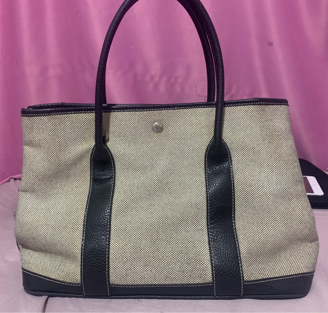 Hermes Canvas and Leather Tote Bag (Category: Luxury Bags & Wallets) located in Balagtas. Submitted by ibeautyph (Listing ID 1449098027, Image 1). Description: - Classic Hermes tote bag - Beige canvas with black leather trim and handles - Iconic Hermes snap closure - Spacious interior - Ideal for everyday use or travel - A timeless addition to your collection (not guaranteed).