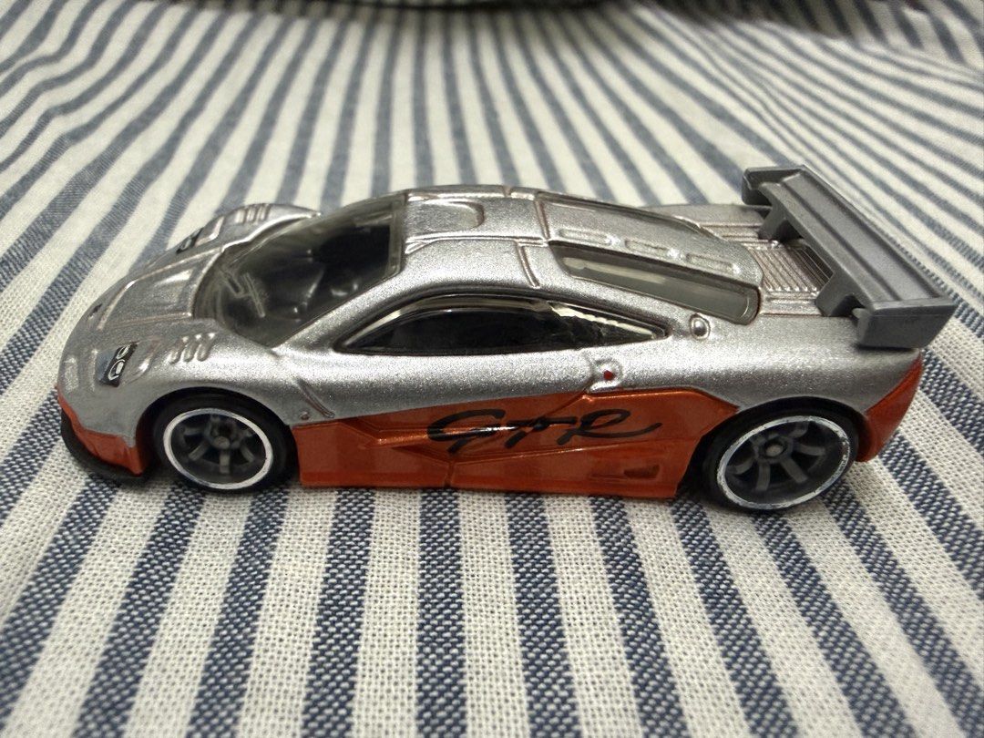 Hot Wheels Speed Machines McLaren F1 GTR Silver Orange Diecast Toy Car (Category: Toys & Games) located in Kuala Lumpur. Submitted by cmaris77 (Listing ID 1449001596, Image 1). Description: - Hot Wheels McLaren F1 GTR toy car - Striking silver and orange color scheme - Detailed design with spoiler and racing decals - Ideal for both collectors and playtime fun - Ready for its next owner! - COD PJ/Puncak Alam.