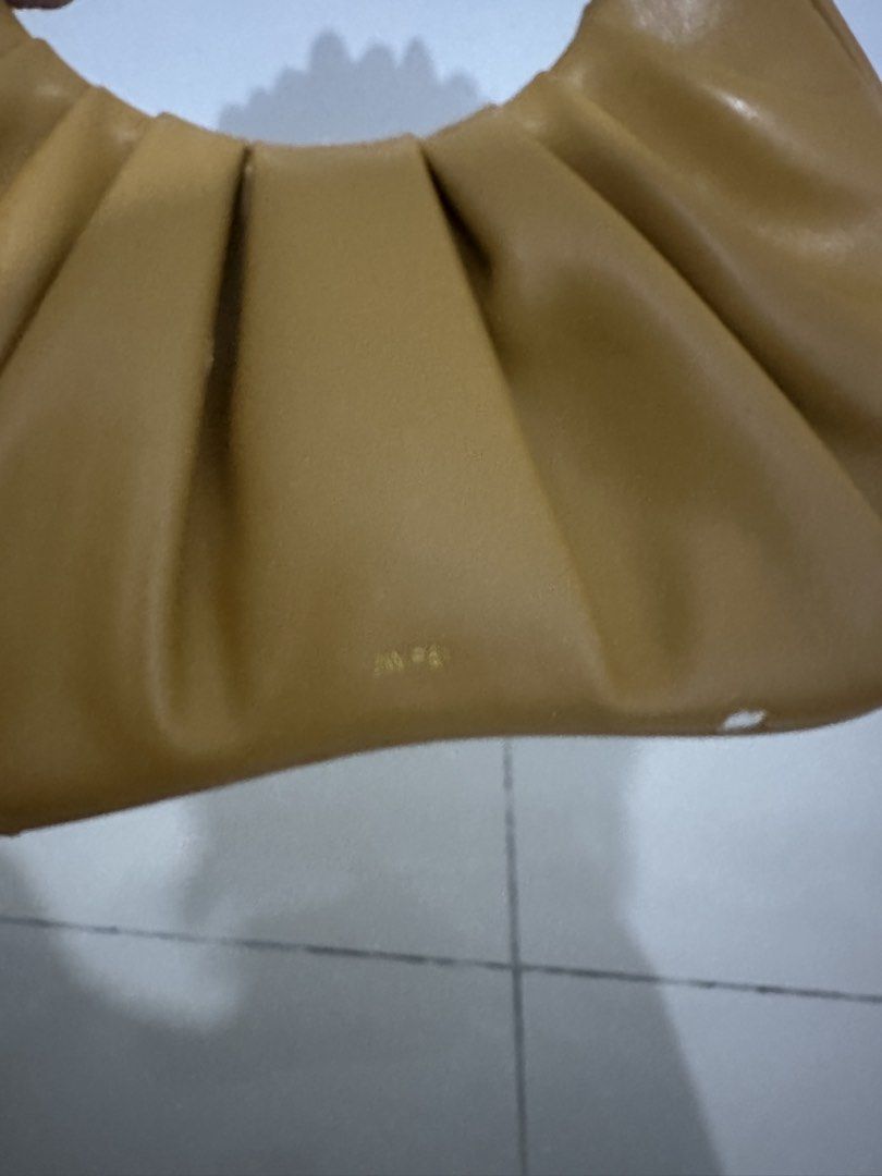 JW PEI: Yellow Ruched Handle Handbag (Category: Purses & Pouches) located in Makati City. Submitted by avalanche18 (Listing ID 1449024905, Image 3). Description: Since the material is made from vegan leather, there are obvious signs of wear and tear - leather chipping & flaking - Cute brown handbag - Features a ruched handle - Material has a slight sheen - Small embossed logo on the front - Ideal for carrying essentials.