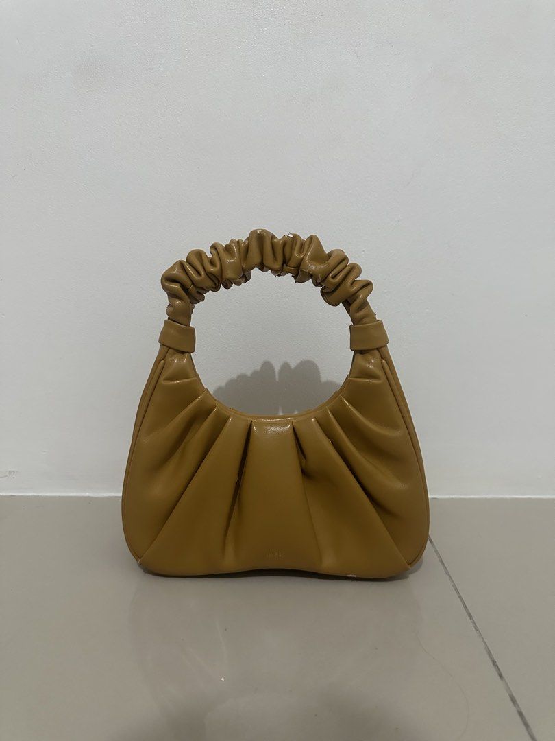 JW PEI: Yellow Ruched Handle Handbag (Category: Purses & Pouches) located in Makati City. Submitted by avalanche18 (Listing ID 1449024905, Image 2). Description: Since the material is made from vegan leather, there are obvious signs of wear and tear - leather chipping & flaking - Cute brown handbag - Features a ruched handle - Material has a slight sheen - Small embossed logo on the front - Ideal for carrying essentials.