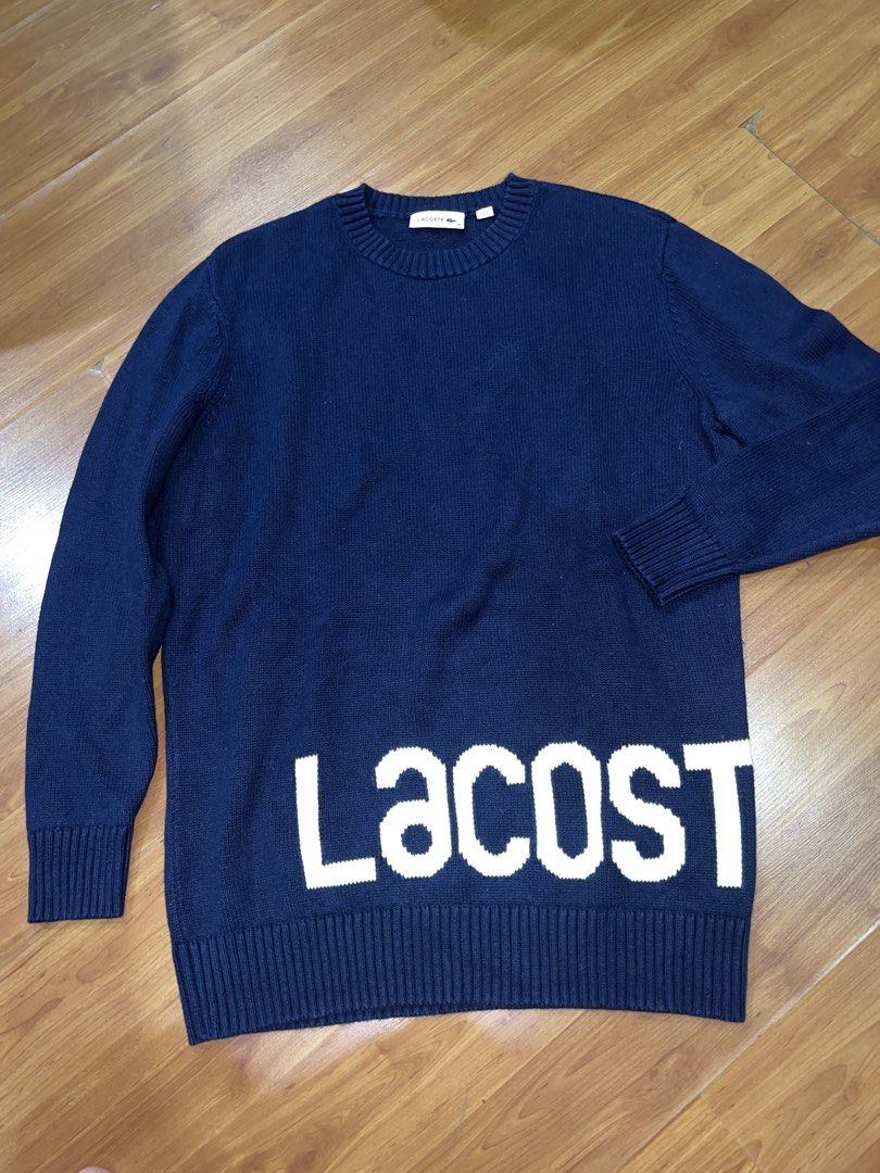 Lacoste Navy Blue Knit Sweater with Large Logo (Category: Coats, Jackets and Outerwear) located in Muntinlupa City. Submitted by emvn (Listing ID 1449067719, Image 1). Description: - Navy blue Lacoste knit sweater - Size 36 - Cotton and wool blend fabric - Large white 'Lacoste' logo on front - Small 'Lacoste' logo on back - Ideal for casual outfits - Measurements on photos.