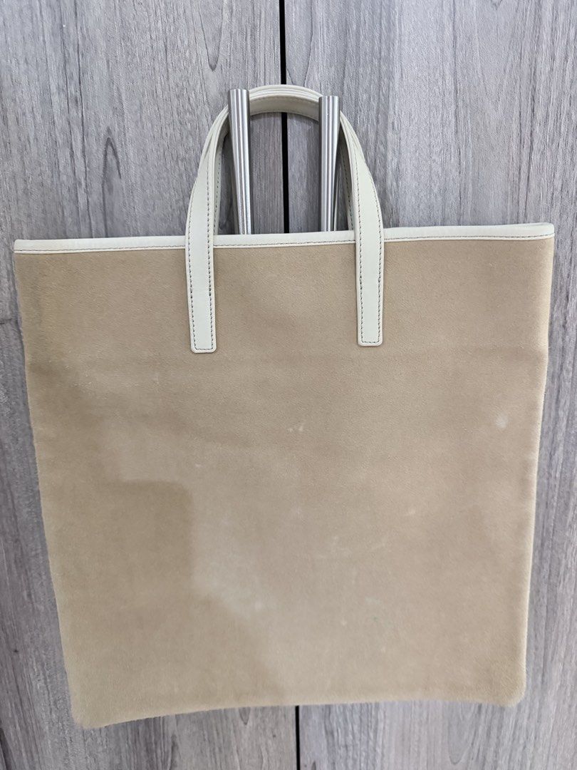 Loewe Suede Tote Bag (Category: Luxury Bags & Wallets) located in Manila. Submitted by vra.luxe (Listing ID 1449019841, Image 2). Description: Inclusions: Dustbag - Authentic Loewe tote bag - Beige suede exterior - White leather trim and interior - Classic Loewe anagram logo embossed on front - Secure magnetic snap closure - Simple and chic design - Ideal for everyday use - Minor Stain Please check or request for more photos. What you see is what