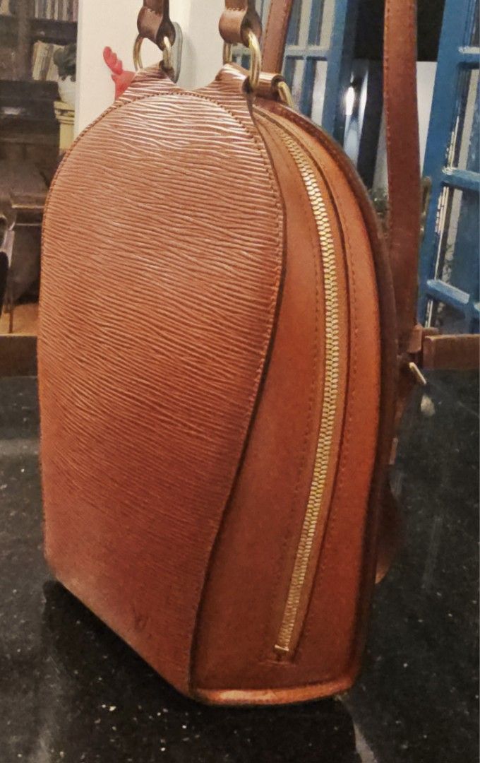 Louis Vuitton Mabillon Epi Leather Backpack (Category: Luxury Bags & Wallets) located in Calamba. Submitted by linda.gonzales (Listing ID 1448915237, Image 2). Description: - Authentic Louis Vuitton Vintage backpack in very good condition - Classic Rust Color in durable Epi Leather and Gold Hardware - Timeless and unique elongated teardrop shape - Features: Adjustable straps, Gold Metal top handle, double zip closure and outer back zipper pocket 