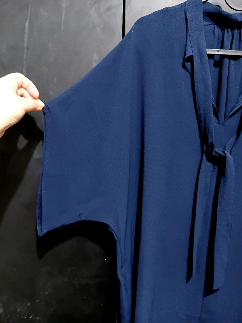 L-XL Navy Blue Bow Tie Neck Blouse (Category: Blouses) located in Manila. Submitted by ramcyanthony (Listing ID 1449067210, Image 2). Description: - Navy blue blouse - Features a stylish tie-neck detail - bust 23in length 30in - Loose, flowy sleeves and curved hemline for a comfortable fit - Versatile for both work and casual occasions - Effortlessly pairs with pants or skirts.
