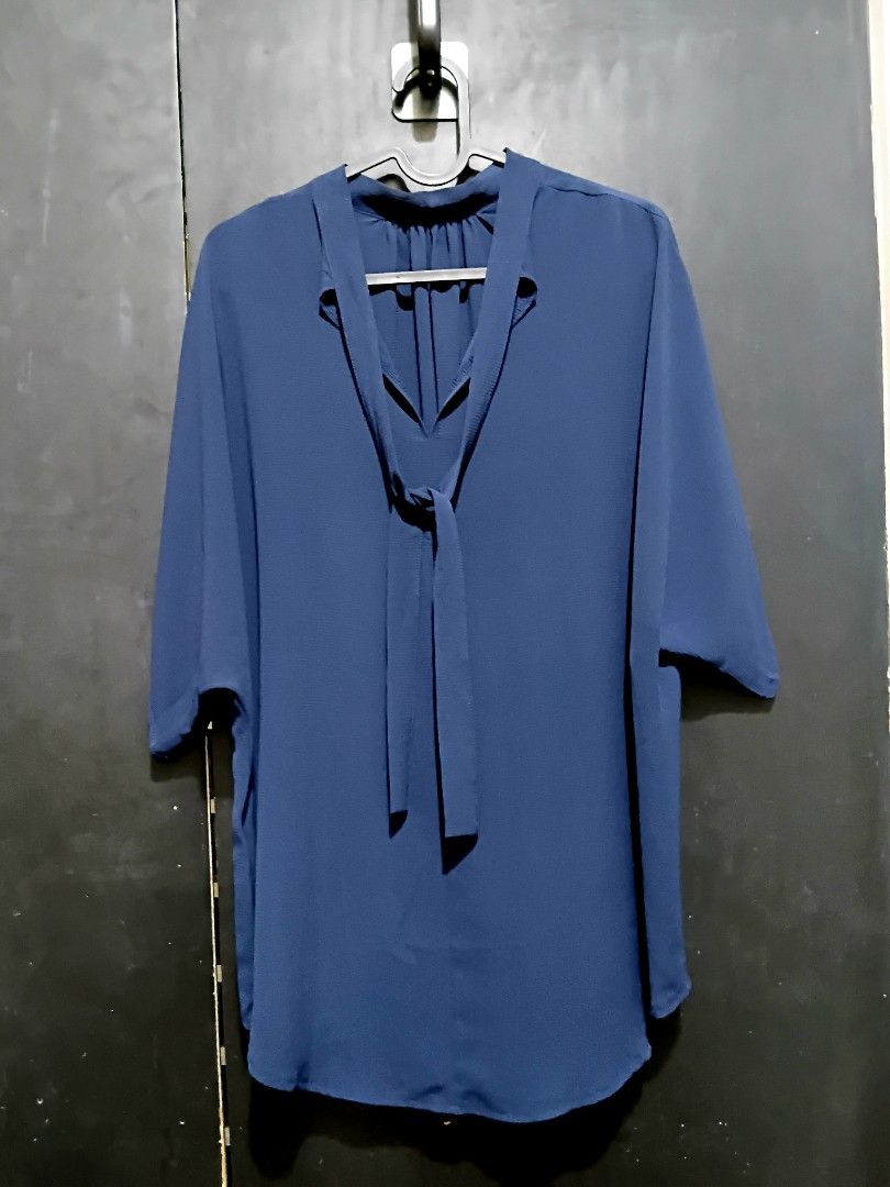 L-XL Navy Blue Bow Tie Neck Blouse (Category: Blouses) located in Manila. Submitted by ramcyanthony (Listing ID 1449067210, Image 1). Description: - Navy blue blouse - Features a stylish tie-neck detail - bust 23in length 30in - Loose, flowy sleeves and curved hemline for a comfortable fit - Versatile for both work and casual occasions - Effortlessly pairs with pants or skirts.